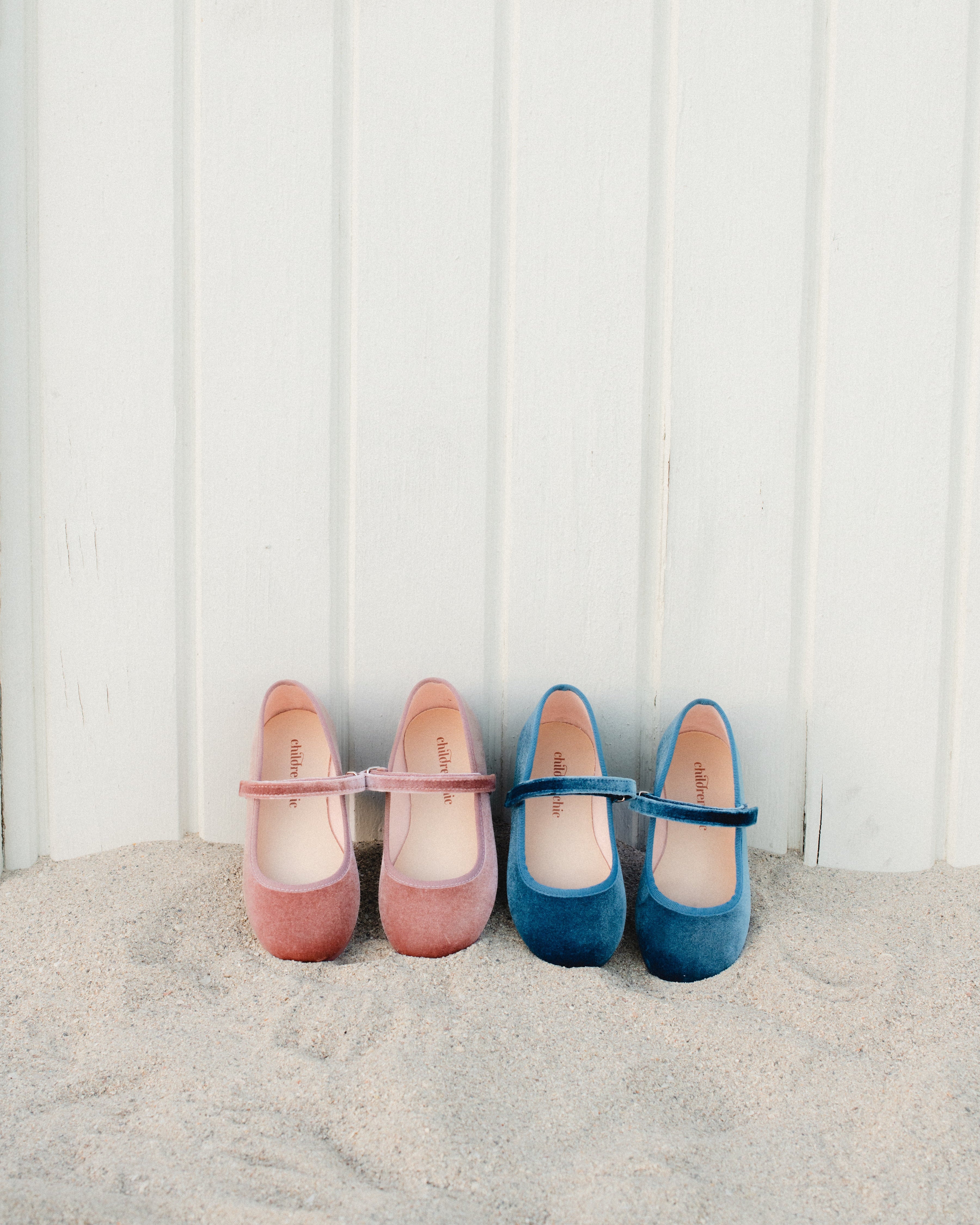 Pair of pink shoes and blue shoes on a white background